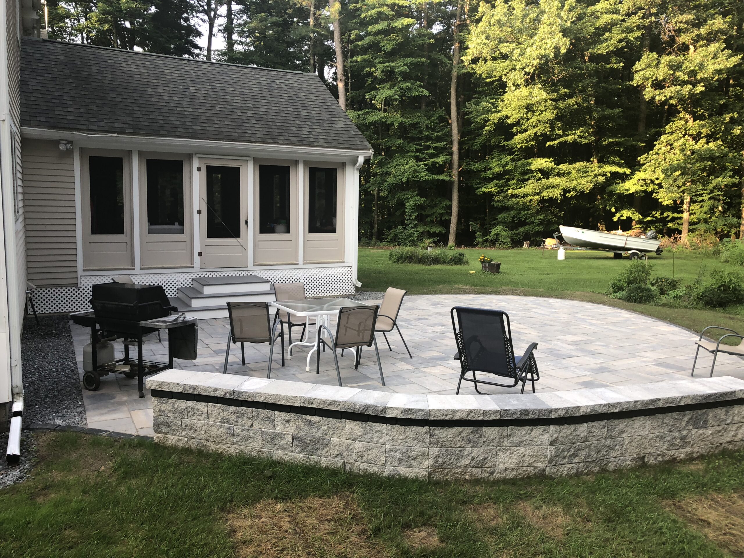 AFTER: CURVED STONE WALL FOR EXTRA SEATING SPACIOUS PATIO FOR RELAXING OR ENTERTAINING